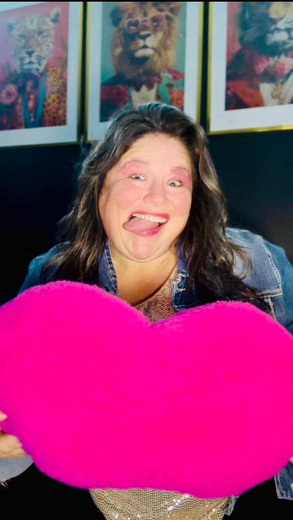 plus size woman holding pink pillow shaped like lips