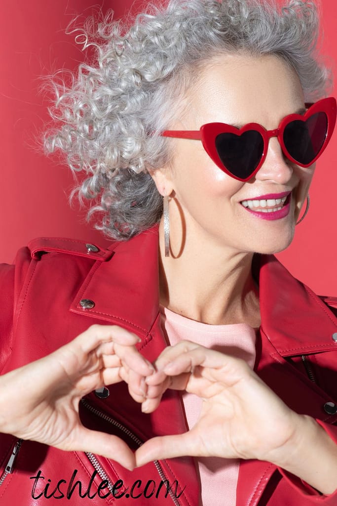 self-love in midlife woman creating heart with her hands