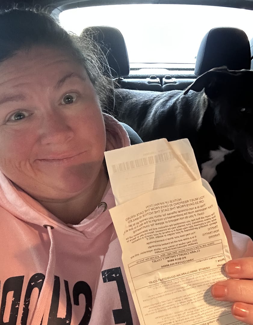 white woman holding speeding ticket